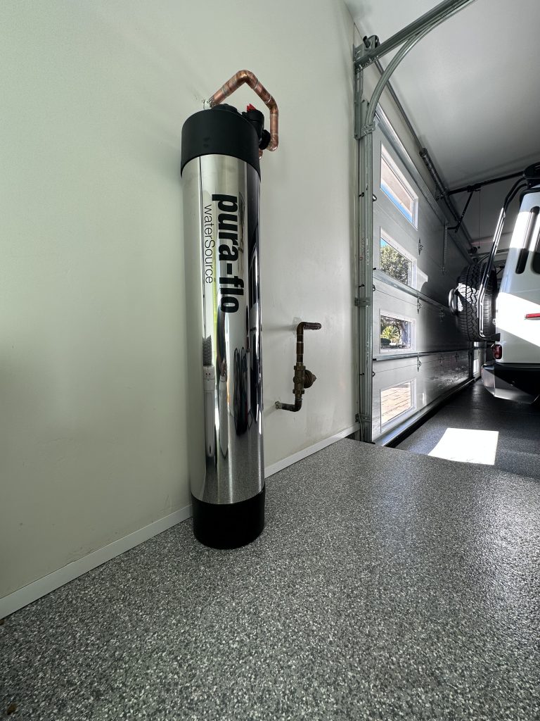 Pura-Flo descalePLUS™ whole-house salt-free water conditioner installed in a garage